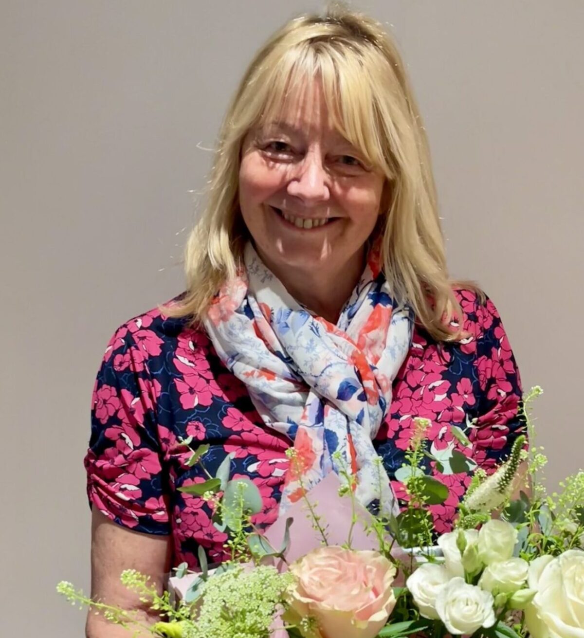 An image of Linda Beresford with flowers